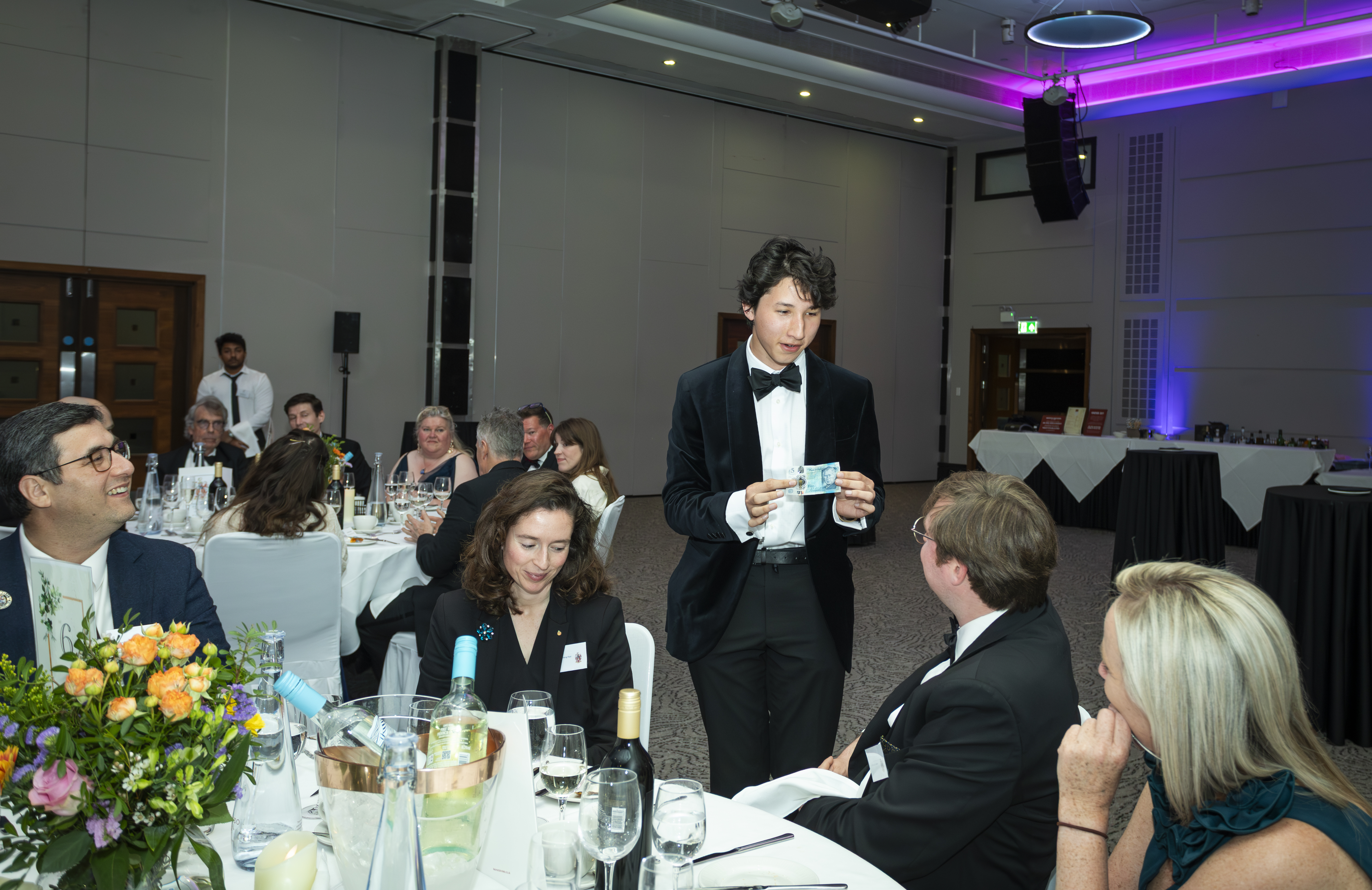 A lively formal event with guests at dinner